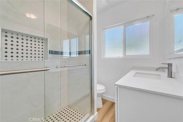 2513 Genevieve St, San Bernardino, CA 92405 - bathroom featuring toilet, plenty of natural light, vanity, and a stall shower