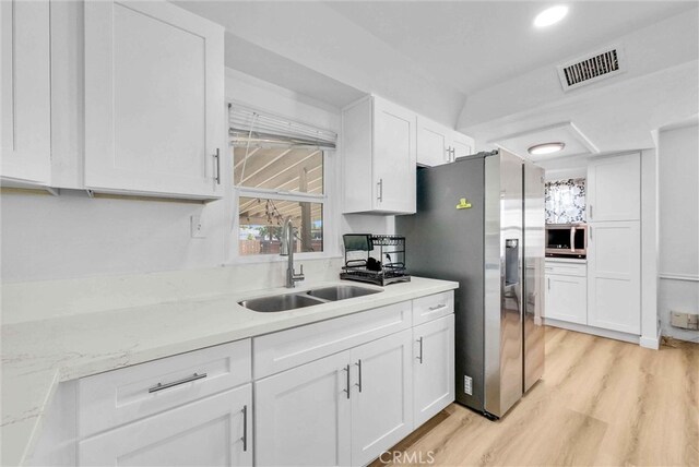 2513 Genevieve St, San Bernardino, CA 92405 - kitchen with a sink, white cabinets, light wood-style floors, stainless steel appliances, and recessed lighting