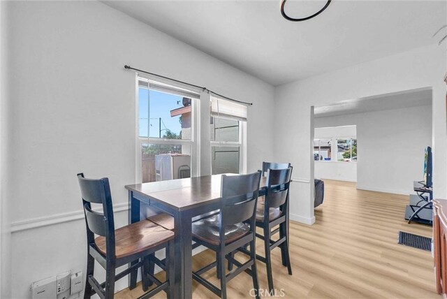 2513 Genevieve St, San Bernardino, CA 92405 - dining room with light wood finished floors, healthy amount of natural light, and baseboards