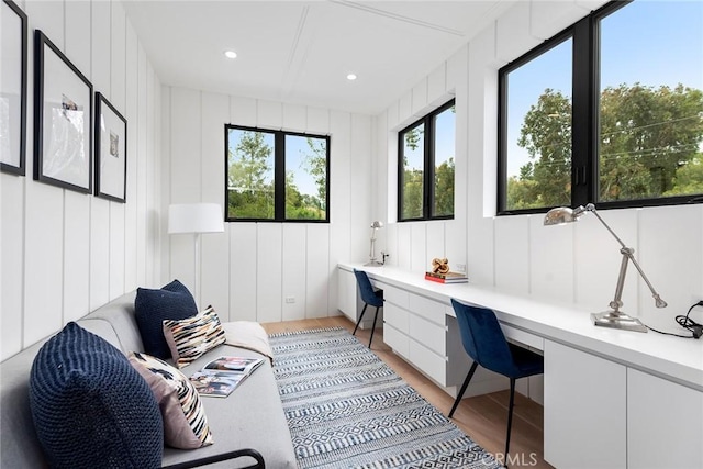 office space featuring built in desk, light wood finished floors, and recessed lighting