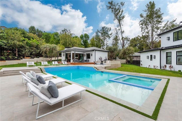 view of pool with a patio area and a pool with connected hot tub