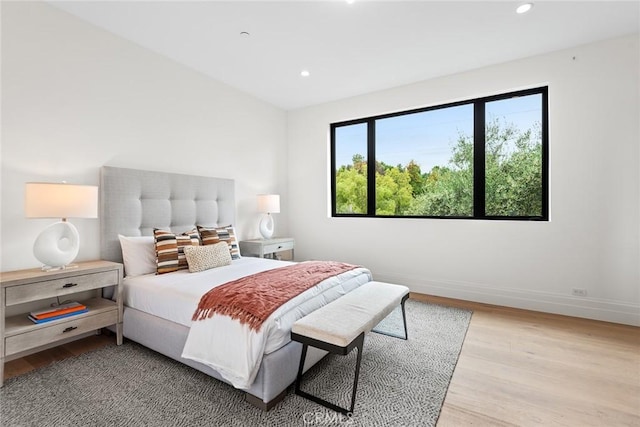 bedroom featuring light wood-type flooring, baseboards, and recessed lighting