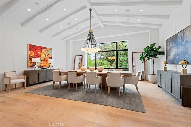 dining room featuring light wood finished floors, recessed lighting, and a decorative wall