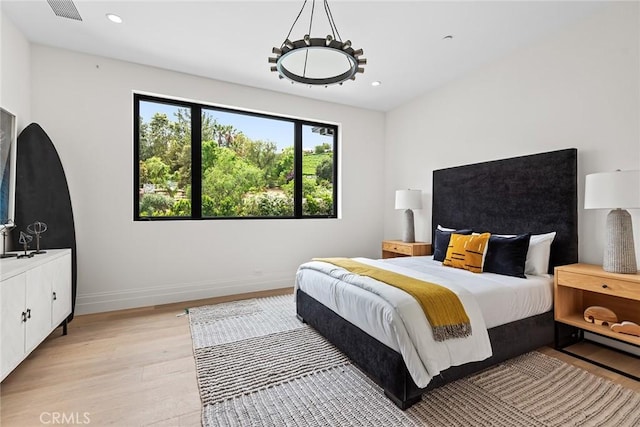 bedroom featuring light wood-type flooring, baseboards, and recessed lighting