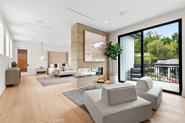 living room featuring light wood-style flooring and recessed lighting