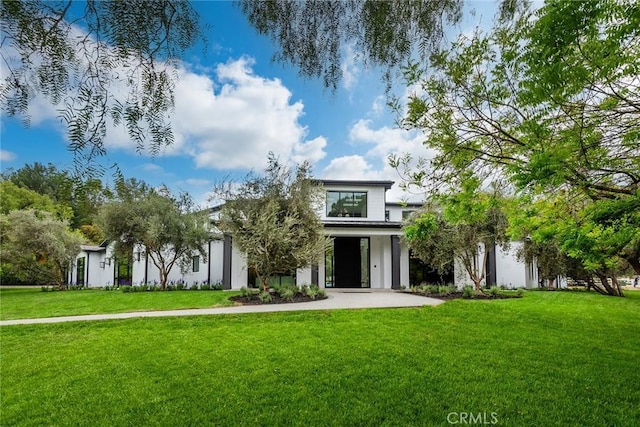 view of front of property with a front lawn and stucco siding