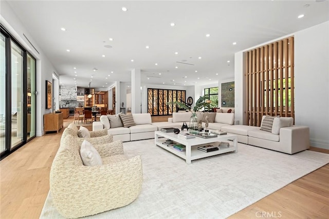 living room with light wood-type flooring and recessed lighting