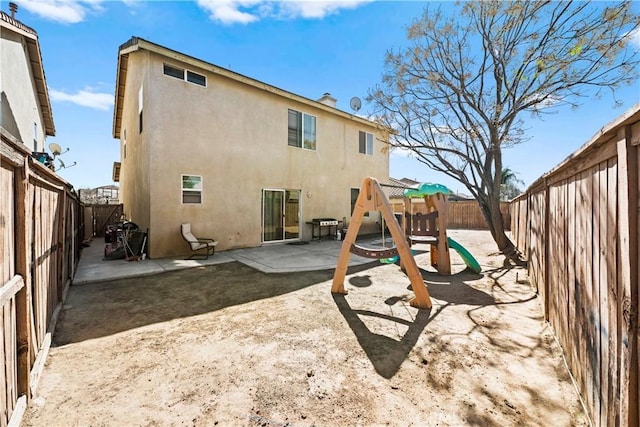 3260 Ivy Ct, Perris, CA 92571 - rear view of property featuring a patio area, a fenced backyard, stucco siding, and a playground