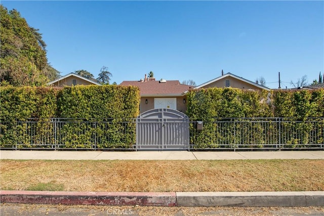 5348 Allott Ave, Sherman Oaks, CA 91401 - view of property hidden behind natural elements featuring a gate and stucco siding
