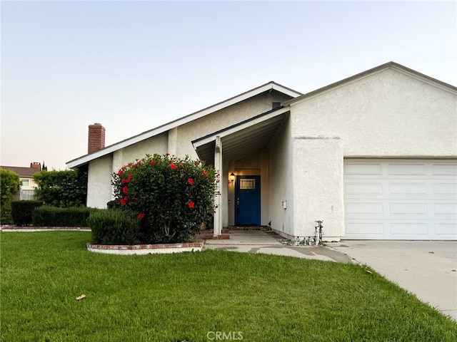 510 Carnation Dr, Placentia, CA 92870 - view of front of property featuring stucco siding, a garage, a chimney, and a front yard