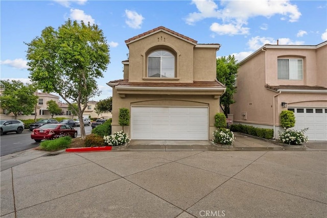 27903 Crown Court Cir Unit 92, Valencia, CA 91354 - mediterranean / spanish-style house with stucco siding and a garage