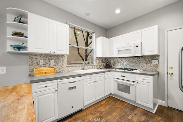 27903 Crown Court Cir Unit 92, Valencia, CA 91354 - kitchen featuring white appliances, a sink, dark wood finished floors, tasteful backsplash, and white cabinets