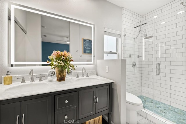 27903 Crown Court Cir Unit 92, Valencia, CA 91354 - bathroom with a shower stall, double vanity, toilet, ceiling fan, and marble look tile flooring
