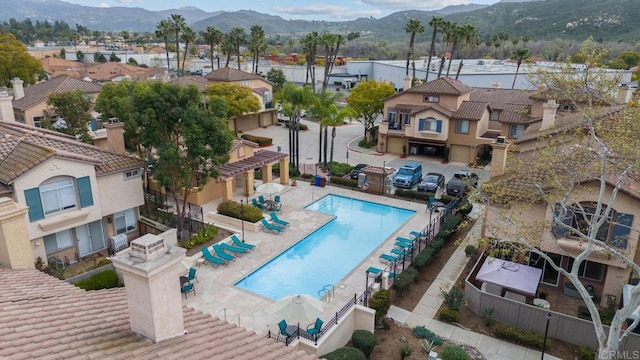 11372 Via Rancho San Diego Unit B, El Cajon, CA 92019 - aerial view of residential area with a mountain backdrop and a pool area
