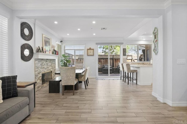11372 Via Rancho San Diego Unit B, El Cajon, CA 92019 - dining room featuring light wood finished floors, recessed lighting, baseboards, a fireplace, and crown molding