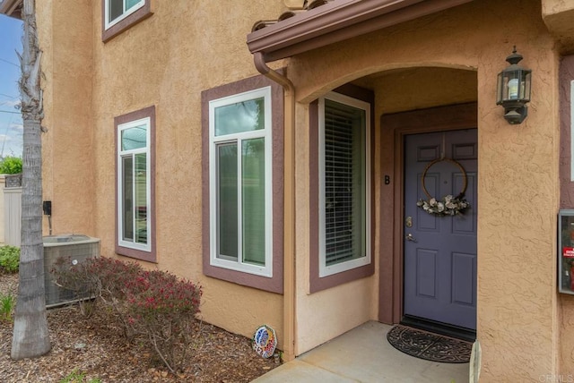 11372 Via Rancho San Diego Unit B, El Cajon, CA 92019 - property entrance with stucco siding and central AC unit