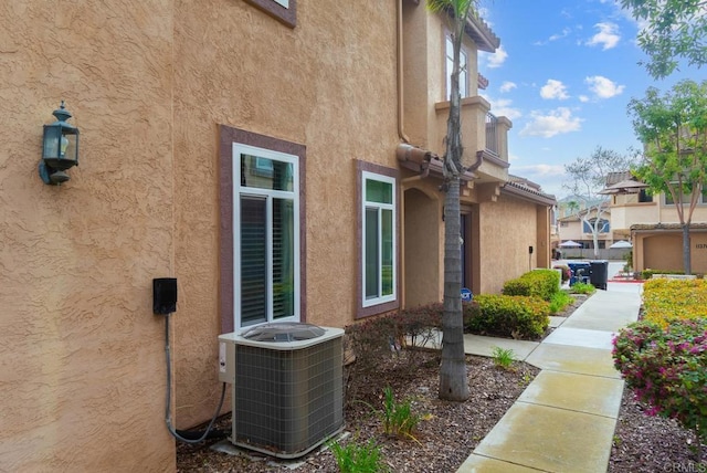 11372 Via Rancho San Diego Unit B, El Cajon, CA 92019 - view of home's exterior featuring cooling unit and stucco siding