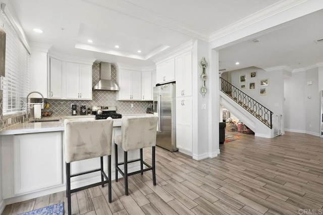 11372 Via Rancho San Diego Unit B, El Cajon, CA 92019 - kitchen featuring wall chimney range hood, a sink, stainless steel appliances, tasteful backsplash, and baseboards