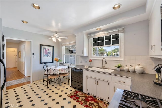 1113 Hollydale Dr, Fullerton, CA 92831 - kitchen with a sink, white cabinets, black dishwasher, a ceiling fan, and backsplash