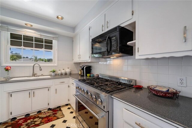 1113 Hollydale Dr, Fullerton, CA 92831 - kitchen with black microwave, high end stainless steel range, a sink, white cabinets, and dark countertops
