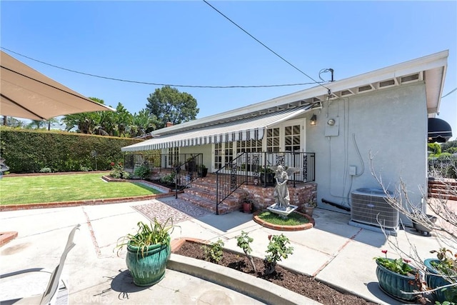1113 Hollydale Dr, Fullerton, CA 92831 - rear view of house featuring a yard, stucco siding, a patio, and central air condition unit