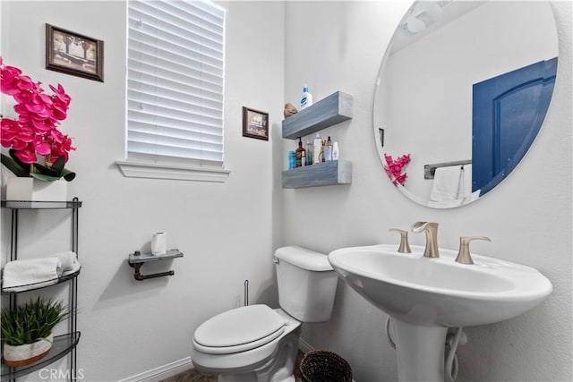 4803 Hawk Ridge Ave, Fontana, CA 92336 - half bathroom featuring toilet, baseboards, and a sink