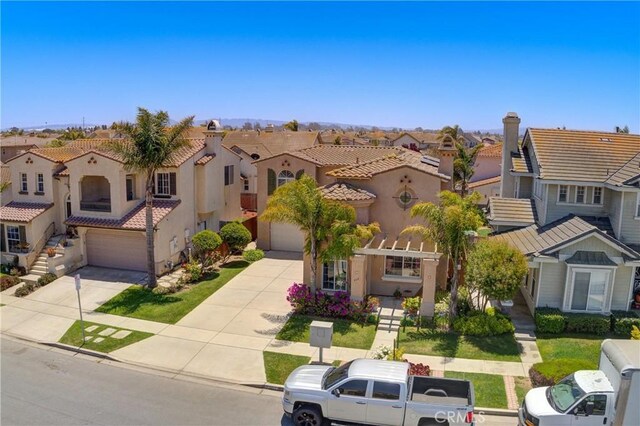 932 Provance Ave, Santa Maria, CA 93458 - view of front of home featuring a residential view, driveway, a garage, stucco siding, and a tile roof