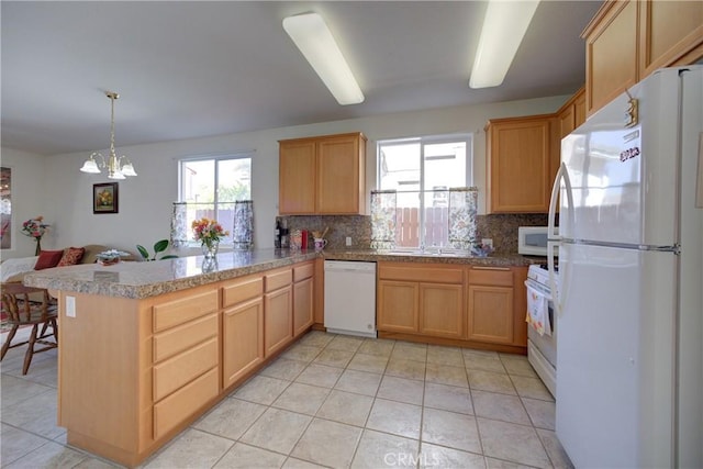 932 Provance Ave, Santa Maria, CA 93458 - kitchen featuring white appliances, plenty of natural light, a peninsula, and decorative backsplash