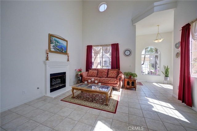 932 Provance Ave, Santa Maria, CA 93458 - living area with light tile patterned flooring, a fireplace with raised hearth, and a high ceiling