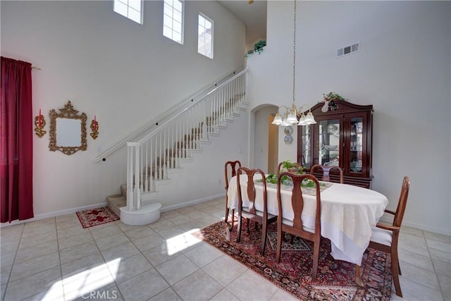 932 Provance Ave, Santa Maria, CA 93458 - dining area featuring a high ceiling, a chandelier, stairs, light tile patterned flooring, and baseboards