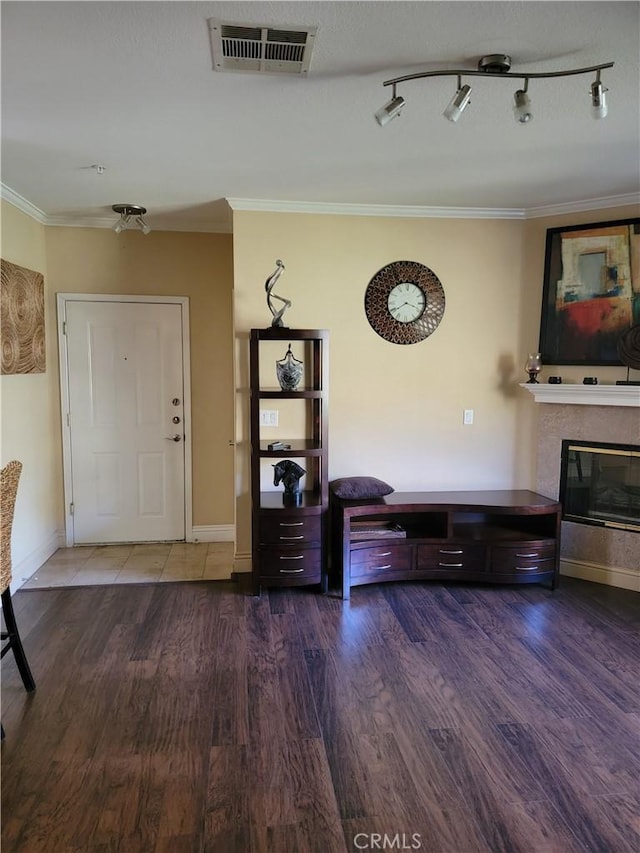 22681 Oakgrove Unit 536, Aliso Viejo, CA 92656 - living room featuring crown molding, wood finished floors, baseboards, and a glass covered fireplace