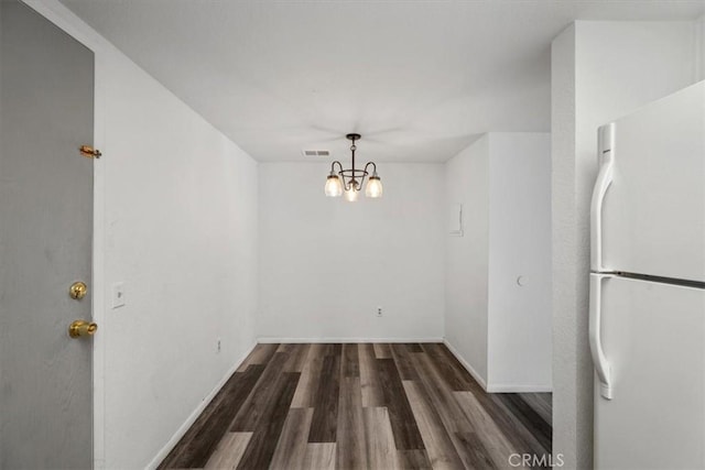 1213 W Cypress Ave Unit D, Lompoc, CA 93436 - unfurnished dining area featuring wood finished floors, a chandelier, and baseboards