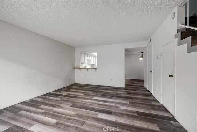 1213 W Cypress Ave Unit D, Lompoc, CA 93436 - empty room with a textured ceiling, wood finished floors, and stairs