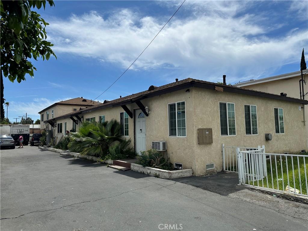 13810 Sherman Way, Van Nuys, CA 91405 - view of side of property with stucco siding and cooling unit