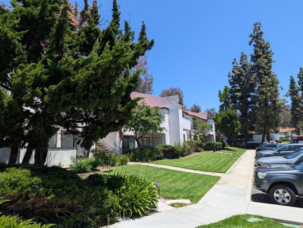 5055 Collwood Way Unit 43, San Diego, CA 92115 - view of front of home with stairway, a front yard, and stucco siding