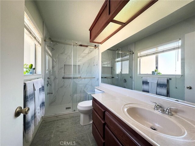 7446 Bangor Ave, Hesperia, CA 92345 - bathroom with a marble finish shower, toilet, vanity, and tile patterned floors