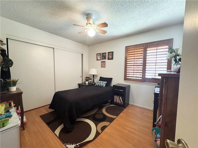 7446 Bangor Ave, Hesperia, CA 92345 - bedroom with a textured ceiling, a closet, wood finished floors, and ceiling fan