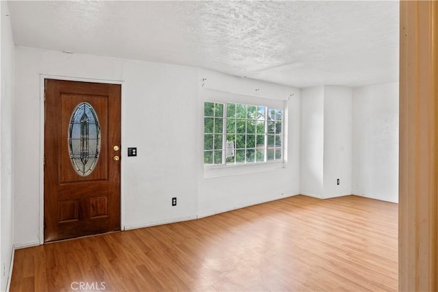 5219 Fleming Rd, Atwater, CA 95301 - foyer entrance featuring wood finished floors, a textured ceiling, and baseboards