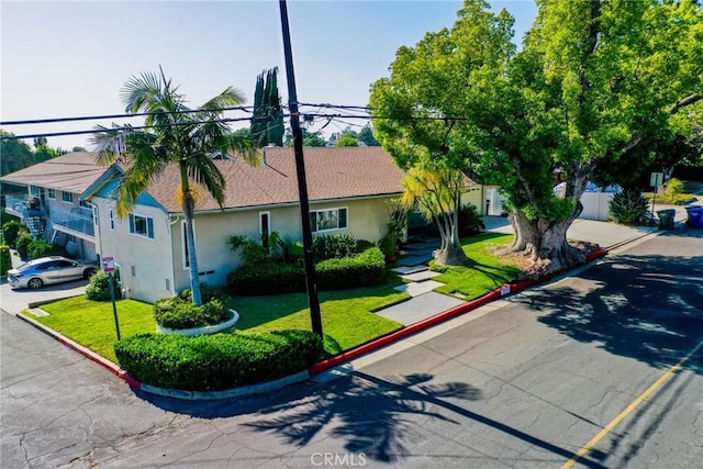 5655 Pickering Ave, Whittier, CA 90601 - view of front of home featuring stucco siding and a front yard