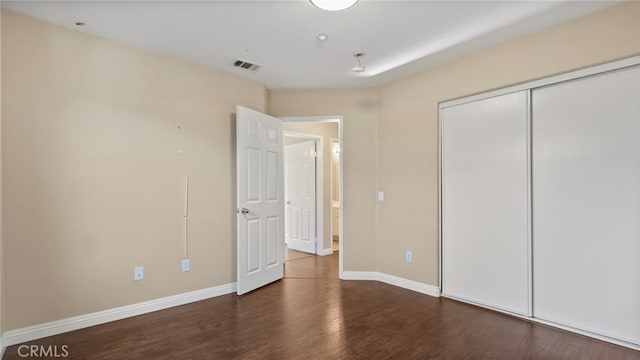 77 Crocus St, Redlands, CA 92373 - unfurnished bedroom with wood finished floors, baseboards, and a closet