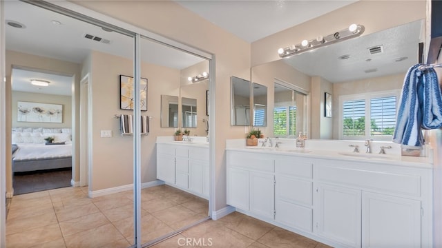 77 Crocus St, Redlands, CA 92373 - ensuite bathroom with double vanity, tile patterned flooring, and baseboards