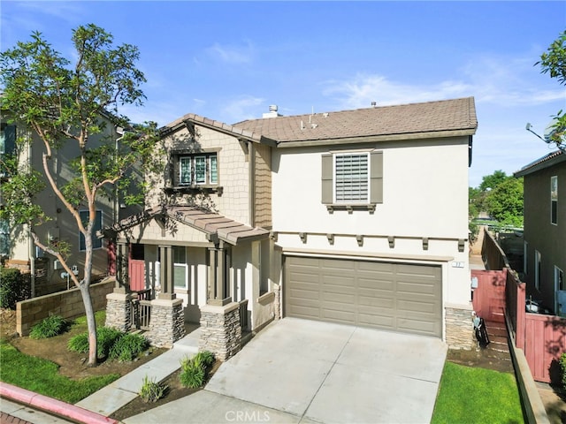 77 Crocus St, Redlands, CA 92373 - view of front of house featuring a garage, concrete driveway, stucco siding, and stone siding