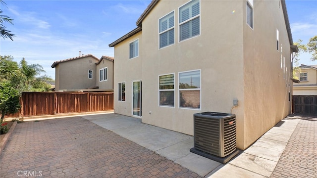 77 Crocus St, Redlands, CA 92373 - rear view of property featuring stucco siding, central air condition unit, and a patio