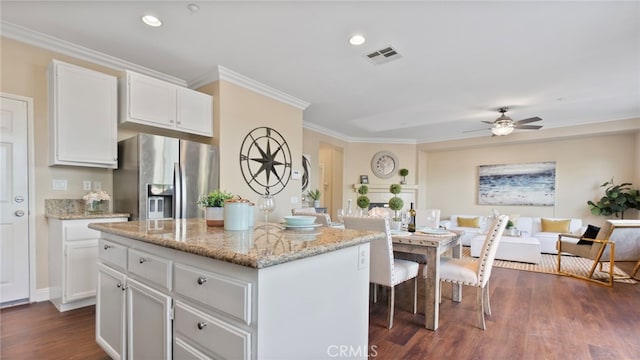 77 Crocus St, Redlands, CA 92373 - kitchen with stainless steel fridge with ice dispenser, white cabinets, crown molding, light stone countertops, and a kitchen island
