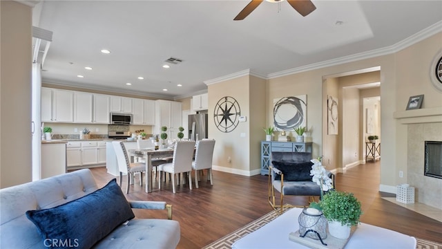 77 Crocus St, Redlands, CA 92373 - living room featuring a fireplace, ornamental molding, a ceiling fan, dark wood finished floors, and baseboards