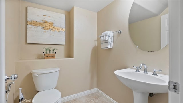 77 Crocus St, Redlands, CA 92373 - bathroom featuring toilet, tile patterned flooring, baseboards, and a sink