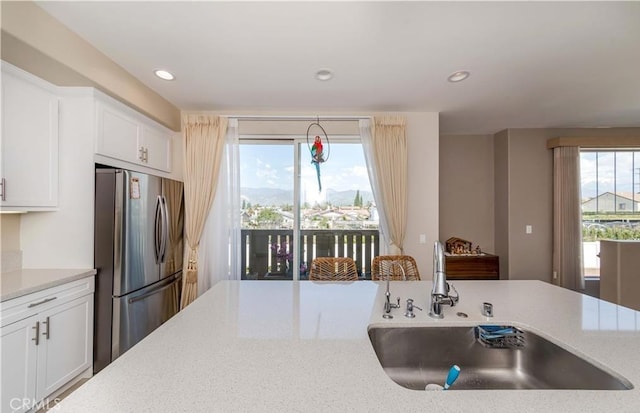 713 S Azusa Ave Unit A, Azusa, CA 91702 - kitchen with freestanding refrigerator, white cabinetry, recessed lighting, and light stone countertops
