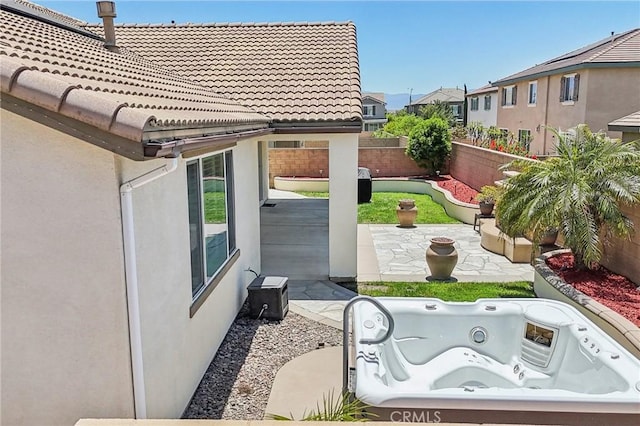 6125 Coopers Hawk Dr, Jurupa Valley, CA 91752 - fenced backyard featuring an outdoor hot tub, a patio, and a residential view