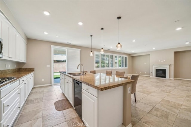 6125 Coopers Hawk Dr, Jurupa Valley, CA 91752 - kitchen with a sink, appliances with stainless steel finishes, recessed lighting, an island with sink, and white cabinets