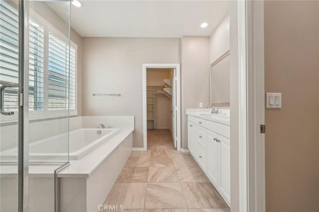 6125 Coopers Hawk Dr, Jurupa Valley, CA 91752 - bathroom featuring vanity, a garden tub, a walk in closet, a shower stall, and recessed lighting